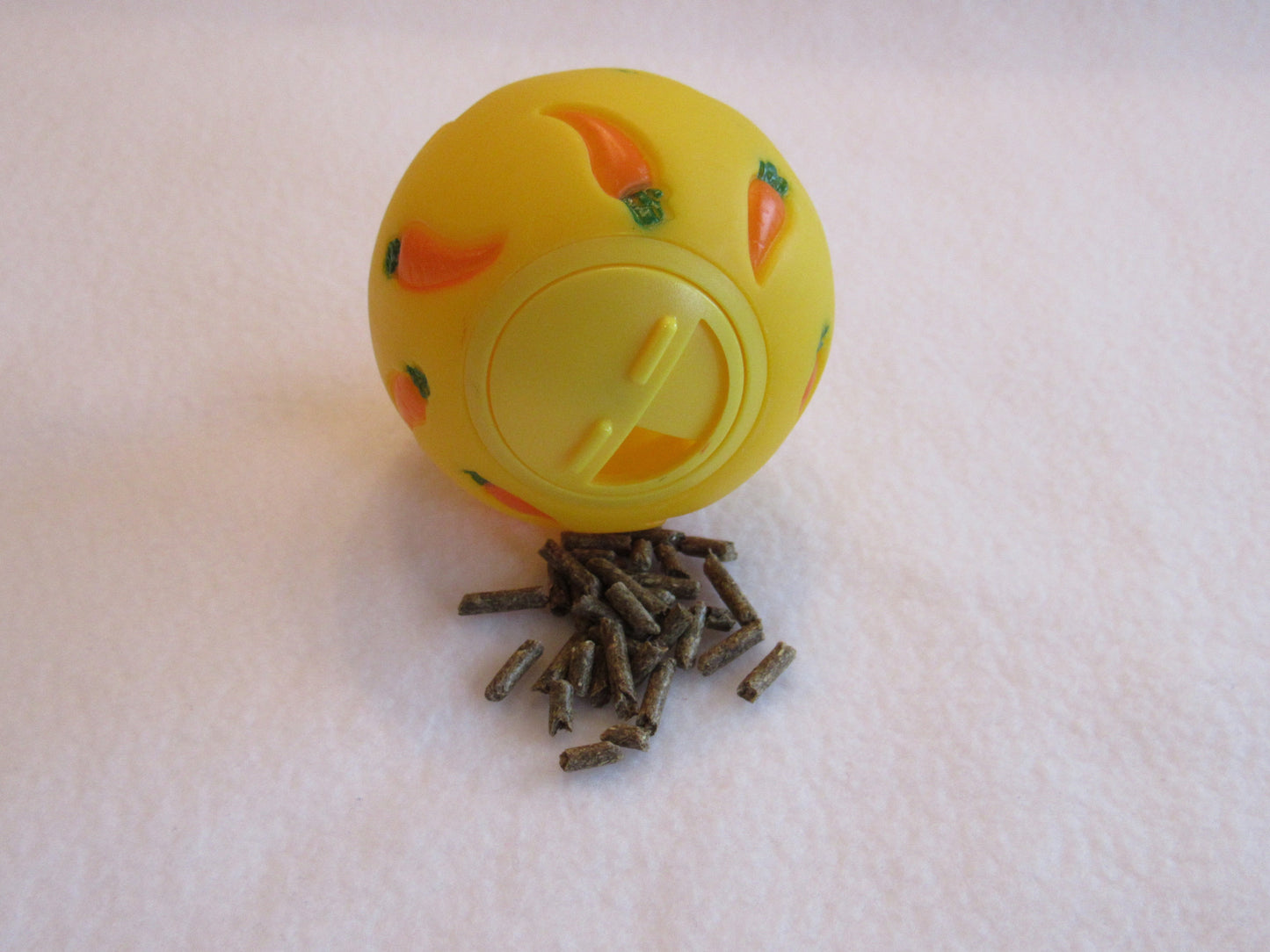 A WheekyⓇ Treat Ball filled with kibble for Guinea Pigs, Rabbits, Hedgehogs and Small Pets.